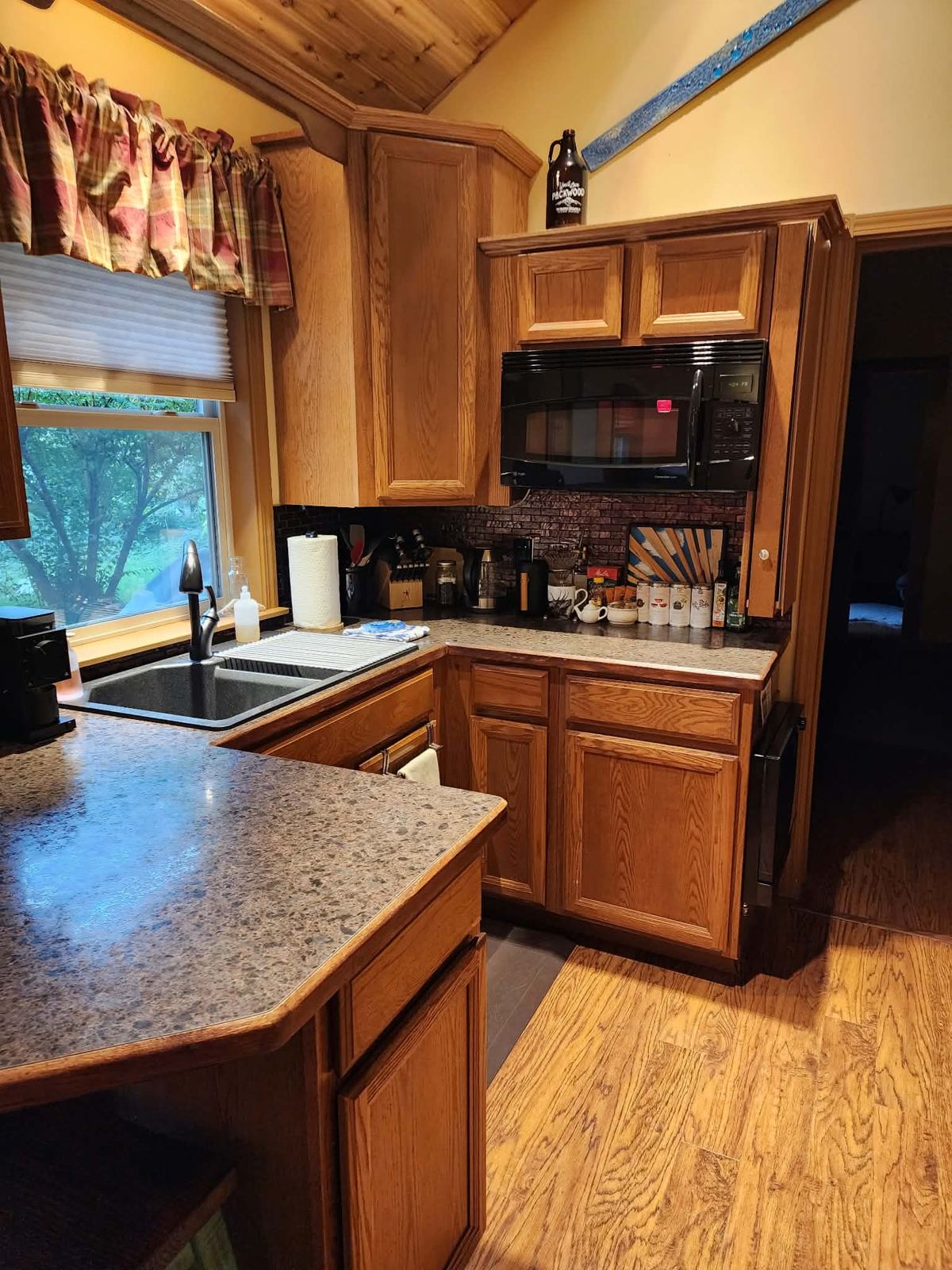 Clean rental kitchen with oak cabinets